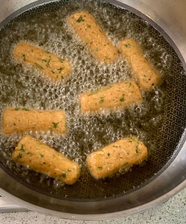 Step 1.1: Once the oil is hot, slide the rolls in batches