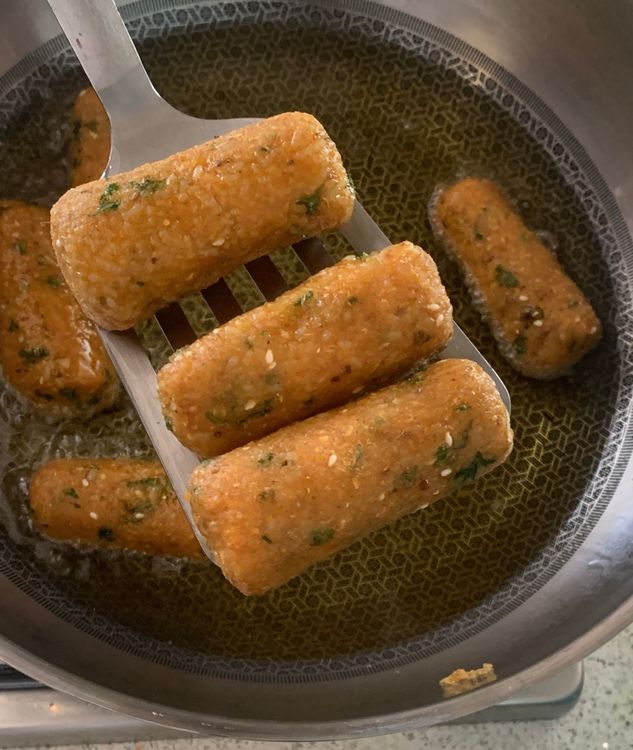 Step 1.1: Use a slotted spoon to remove the fried fritters from the oil, allowing excess oil to drain on a paper towel