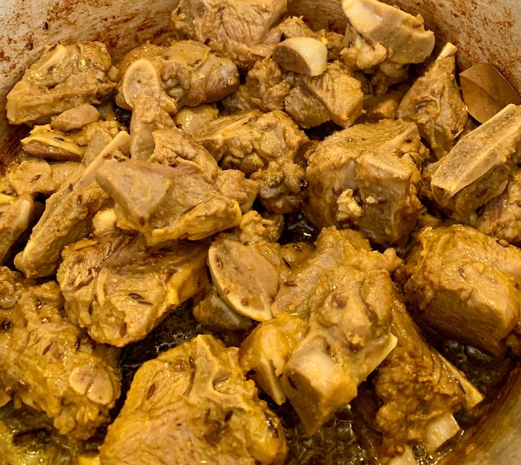 Step 3.1: Once the goat pieces have lightened in colour, then take them out of the pot and keep aside in a plate for later use
