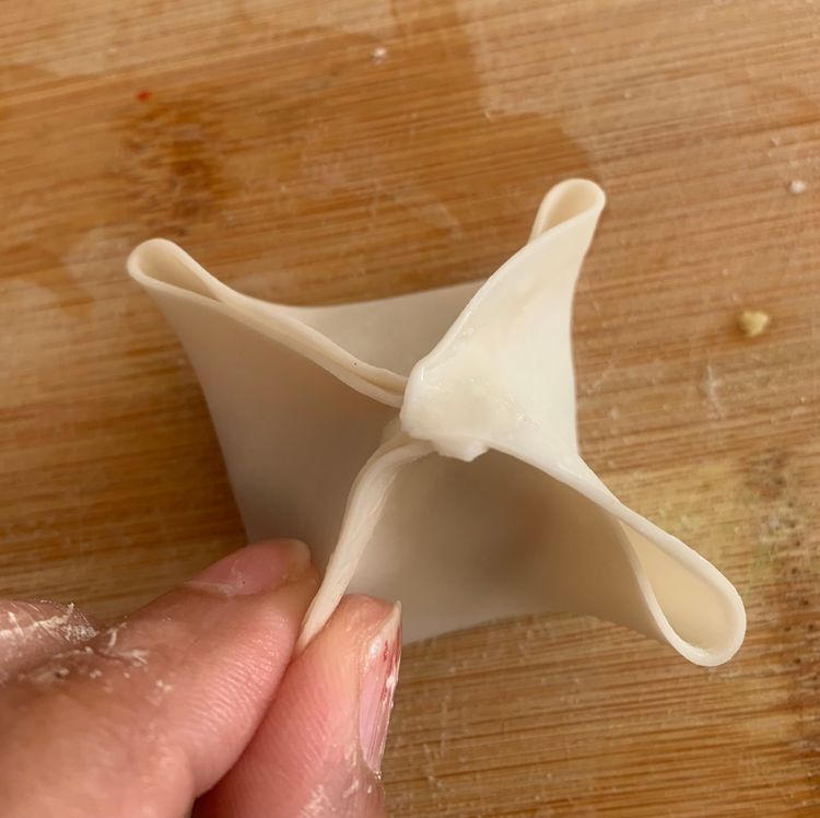 Step 3.1: Moisten the edges of the wrapper lightly with water