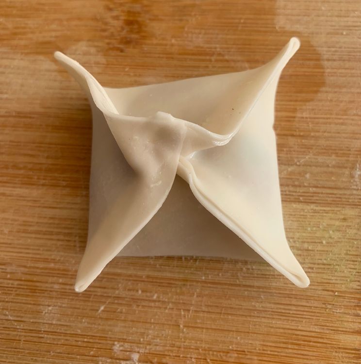 Step 3.2: Moisten the edges of the wrapper lightly with water