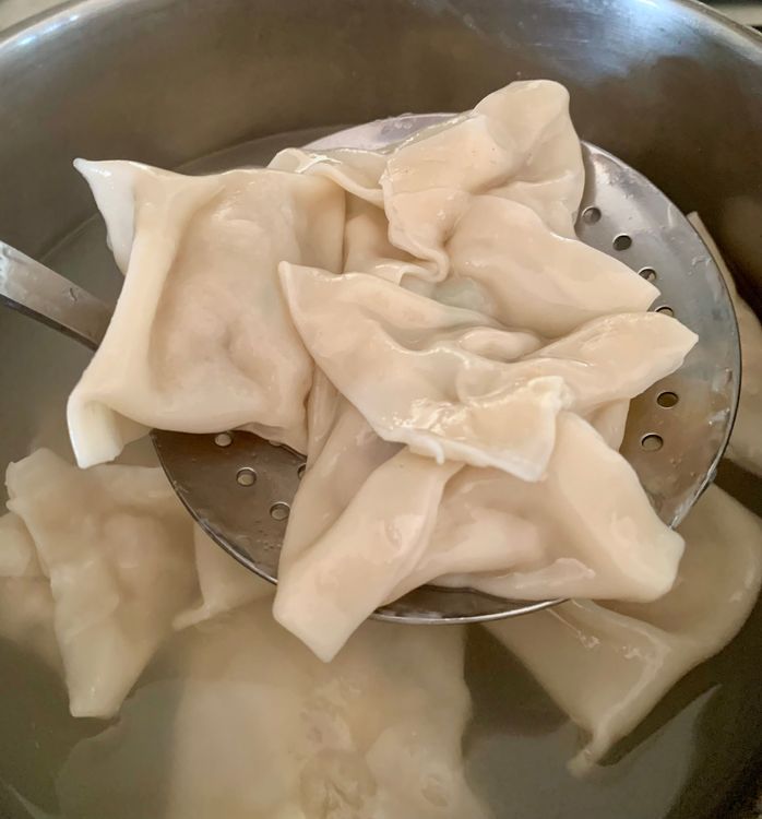Step 4.1: Remove the wontons with a slotted spoon, drain well, and transfer to a serving plate