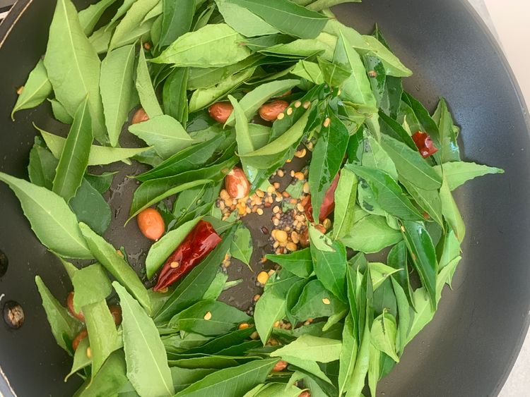 Step 1.1: Add the dry red chillies and curry leaves, sautéing for a few seconds until the curry leaves turn slightly crisp