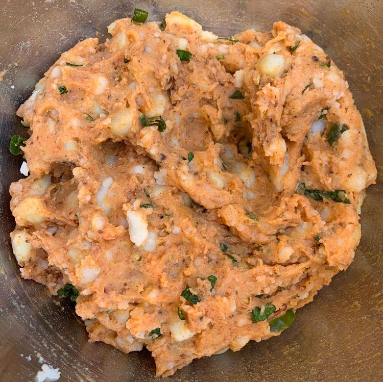 Step 1.2: Add green chillies, chopped mint and coriander leaves, kashmiri red chilli powder, coriander powder, cumin powder, pomegranate seeds, carom seeds, chat masala, and salt