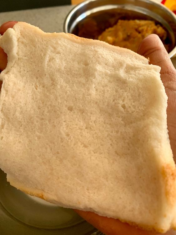 Step 1.1: Dip a bread slice slightly in a bowl of water and press flat with both your hands gently to squeeze out the water