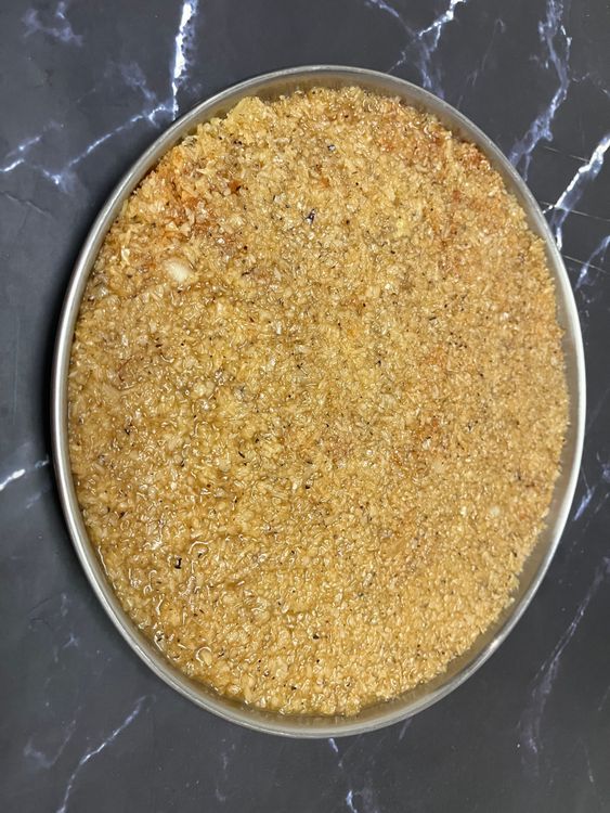 Step 6.2: Grease a steel plate or tray with ghee
