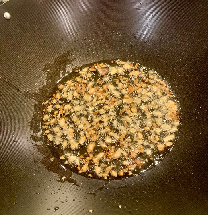 Step 2.1: Add the chopped garlic to the wok and sauté for a minute or until fragrant