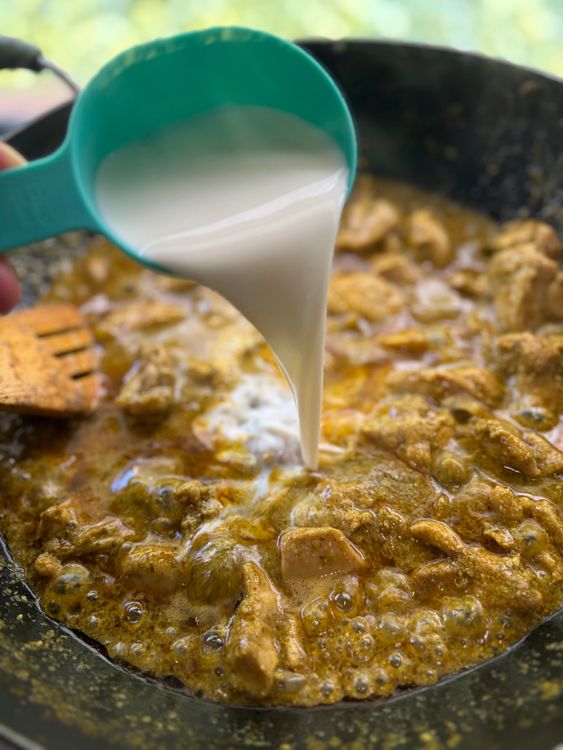 Step 3.1: Pour in the milk and add the slit green chilli