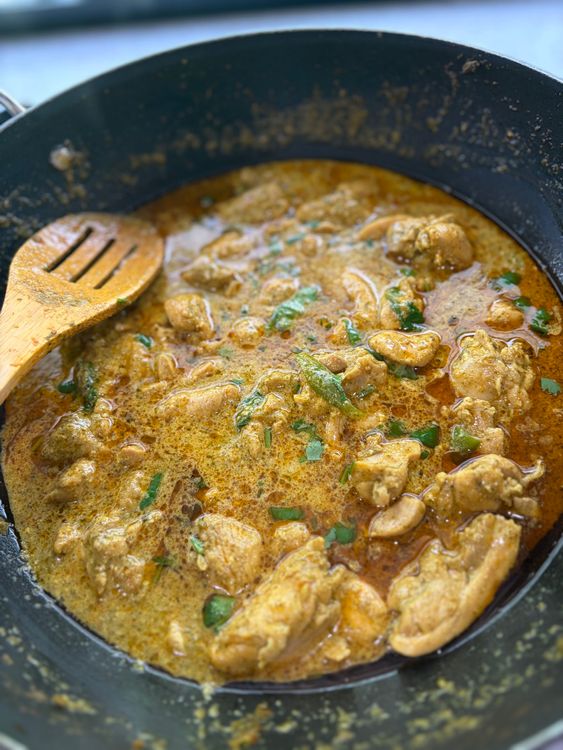 Step 3.2: Pour in the milk and add the slit green chilli