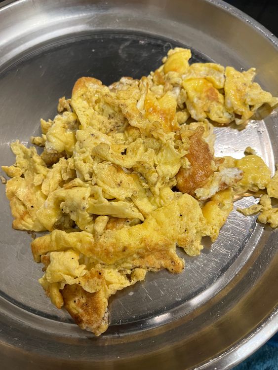 Step 2.1: Flip the omelette once set, cook the other side, and transfer to a plate