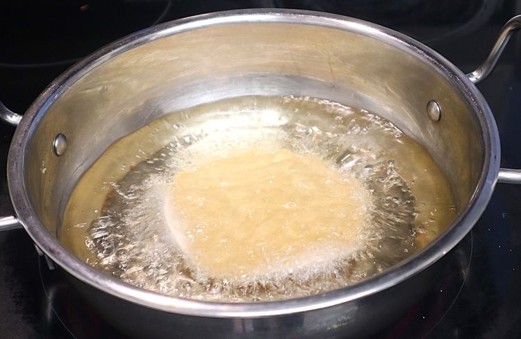Step 1.1: Press until the poori puffs up and splash oil to puff up fully