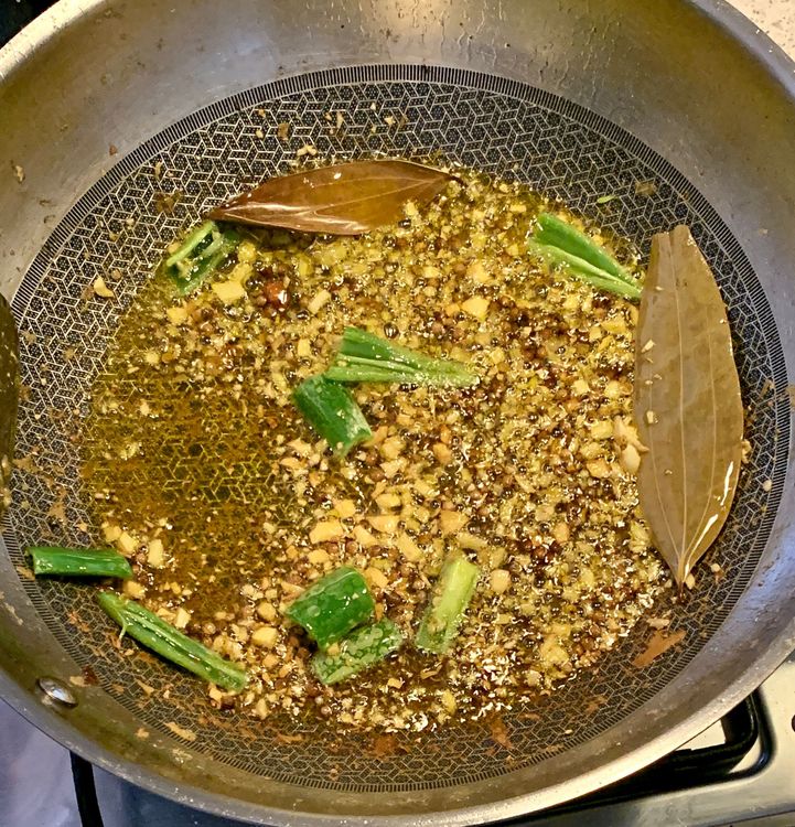 Step 1.1: Add the chopped ginger, garlic and green chillies to the wok