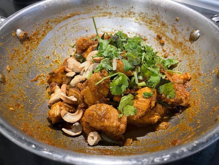 Step 6.2: Fry cashews until golden brown and pour this tempering over the chicken fry