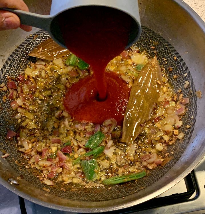 Step 1.1: Pour in the tomato puree and mix well for a minute