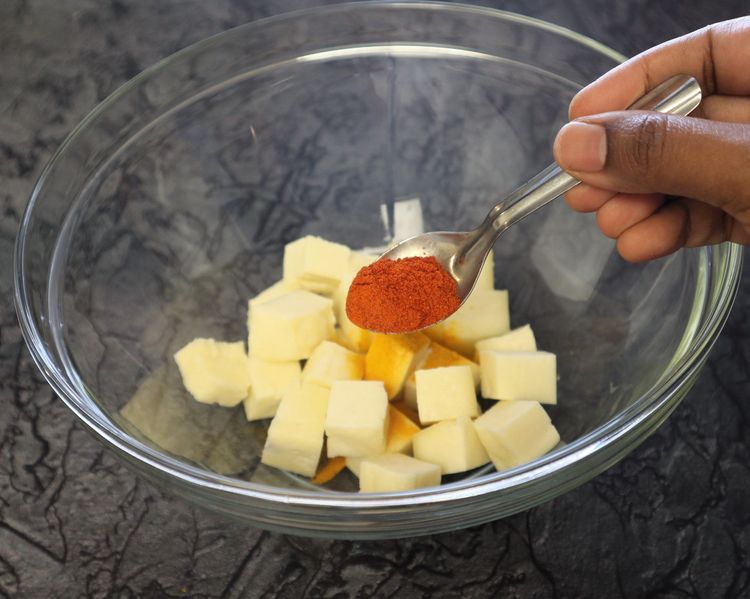 Step 1.4: In a large bowl, take paneer cubes, turmeric, chilli powder, ginger garlic paste, and salt