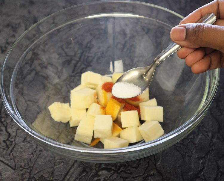 Step 1.6: In a large bowl, take paneer cubes, turmeric, chilli powder, ginger garlic paste, and salt