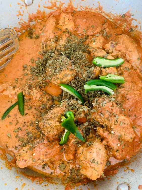 Step 3.1: Add the cooked chicken pieces, kasuri methi, green chillies, and water