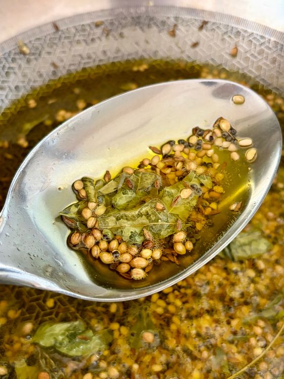 Step 3.1: Add urad dal, coriander seeds, cumin seeds, and curry leaves