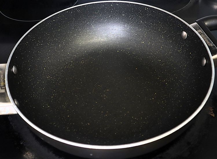 Step 2.1: In a large kadai, heat ghee and oil