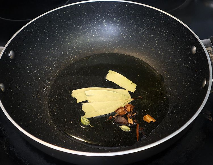 Step 2.3: Add cumin, bay leaf, black cardamom pod, cinnamon, cardamom pods, and cloves
