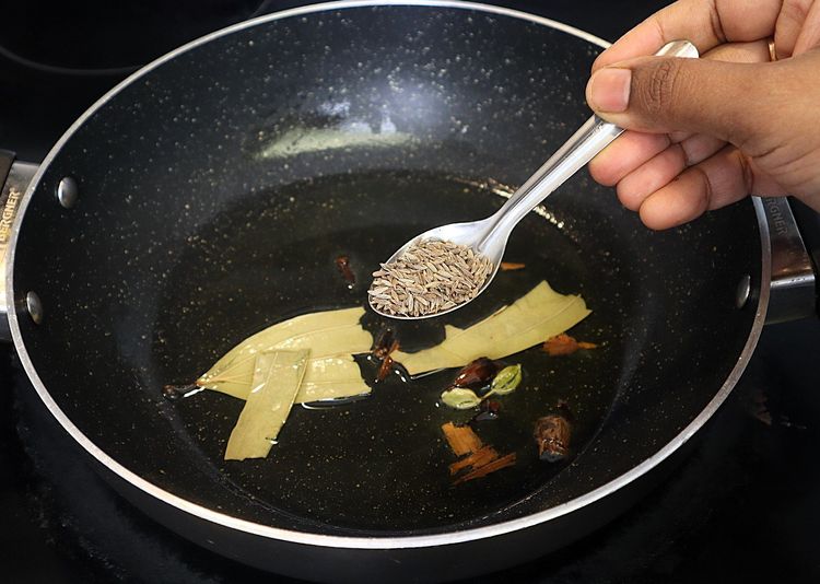 Step 2.4: Add cumin, bay leaf, black cardamom pod, cinnamon, cardamom pods, and cloves