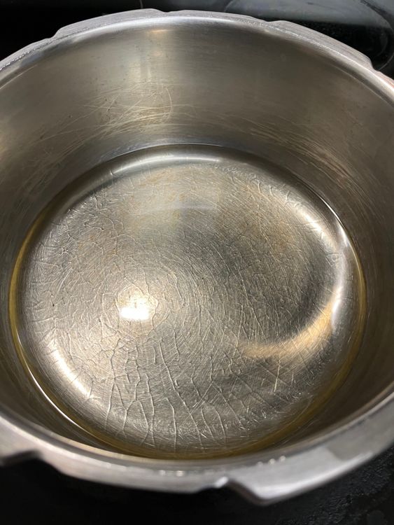 Step 2.1: In a deep kadai, heat oil and fry the peanuts until the skin separates