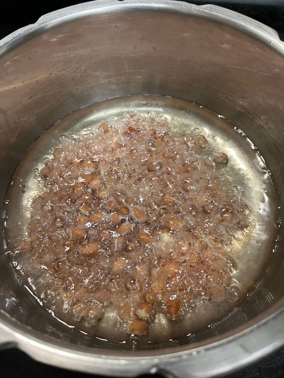 Step 2.2: In a deep kadai, heat oil and fry the peanuts until the skin separates