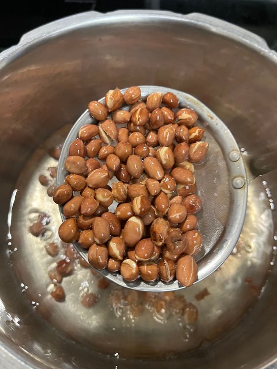 Step 2.3: In a deep kadai, heat oil and fry the peanuts until the skin separates