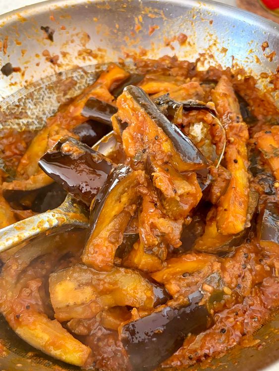 Step 4.1: Reduce the heat, cover and cook until the brinjals turn soft and fully cooked
