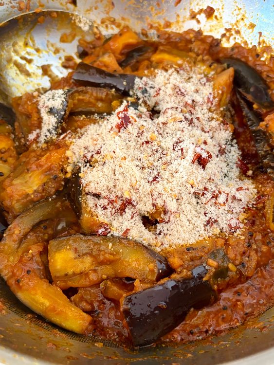 Step 5.1: Add the coarse red chilli–coconut mixture, mix gently, cover, and simmer for another 4–5 minutes for the flavours to come together