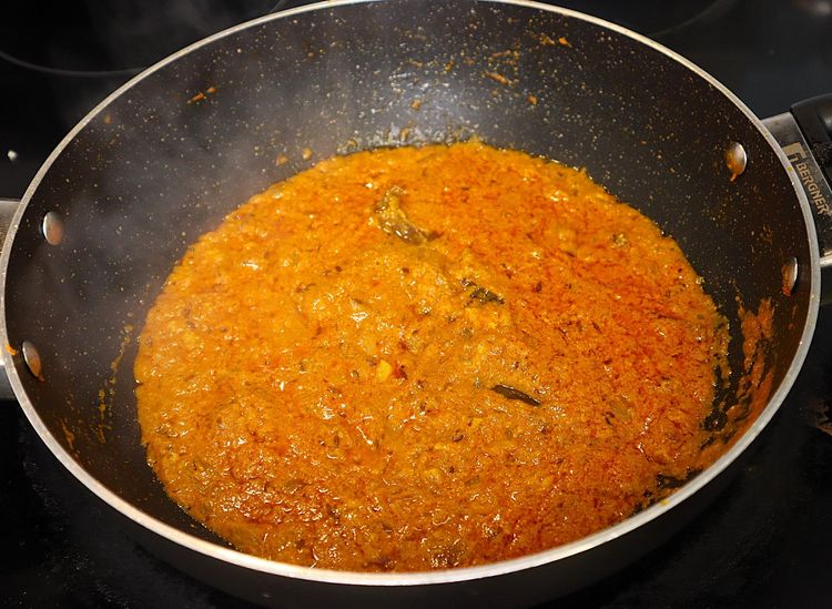 Step 2.3: Keeping the flame on low, add curd and stir continuously