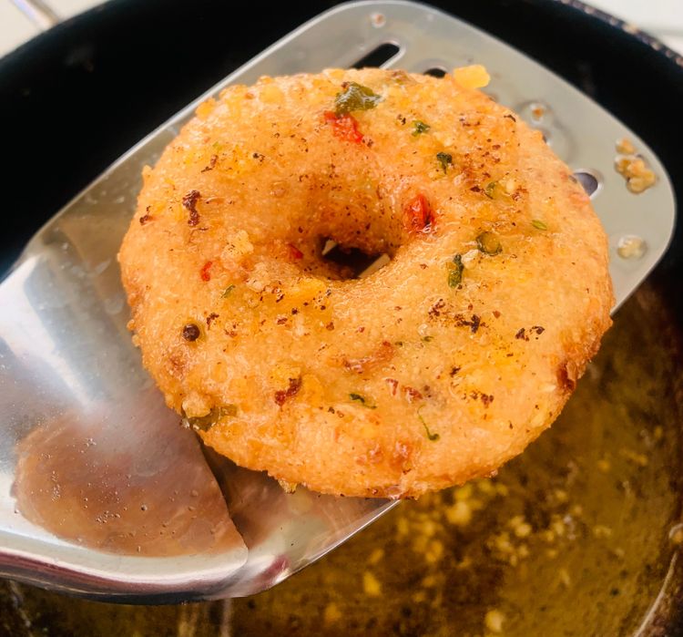 Step 2.1: Once the oil is hot, carefully slide the suji vadas into the oil