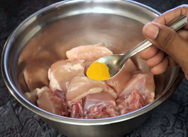 Step 1.2: Marinate the chicken with turmeric powder, salt, red chili powder, and oil
