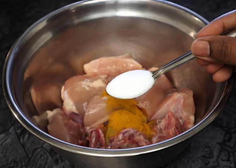 Step 1.3: Marinate the chicken with turmeric powder, salt, red chili powder, and oil