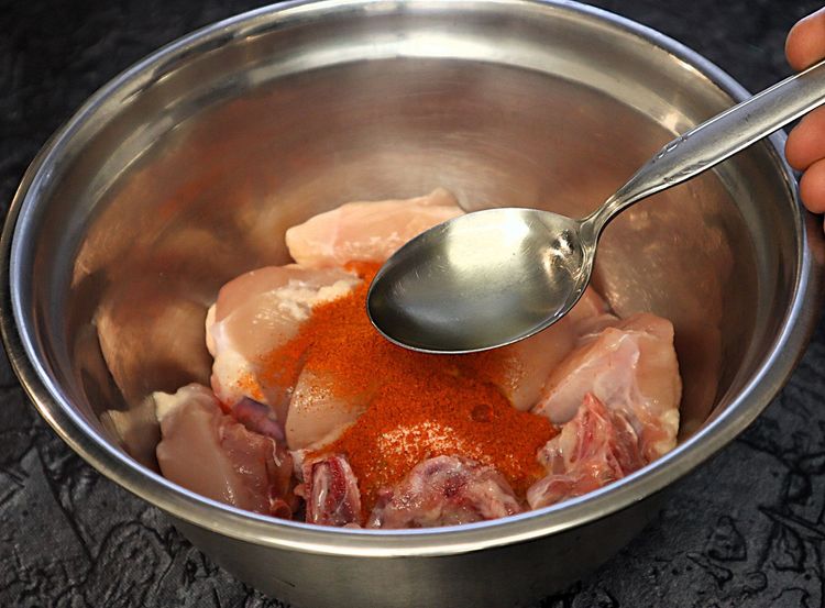 Step 1.5: Marinate the chicken with turmeric powder, salt, red chili powder, and oil