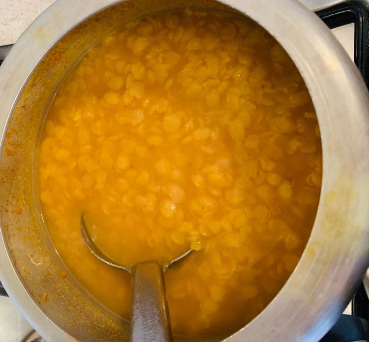 Step 1.1: Close the lid of the pressure cooker and cook the dal on medium heat for 1-2 whistles or until the dal is soft and cooked through