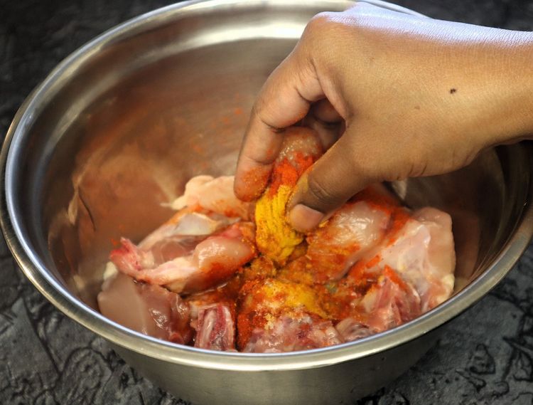 Step 1.7: Marinate the chicken with turmeric powder, salt, red chili powder, and oil