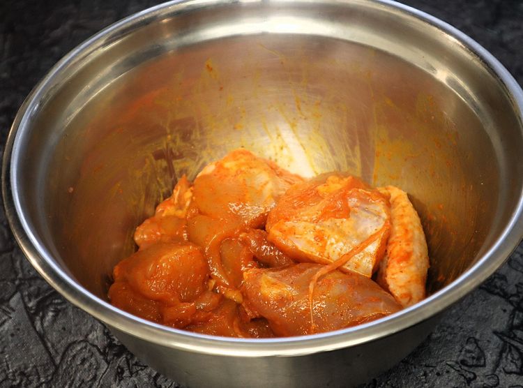 Step 1.8: Marinate the chicken with turmeric powder, salt, red chili powder, and oil