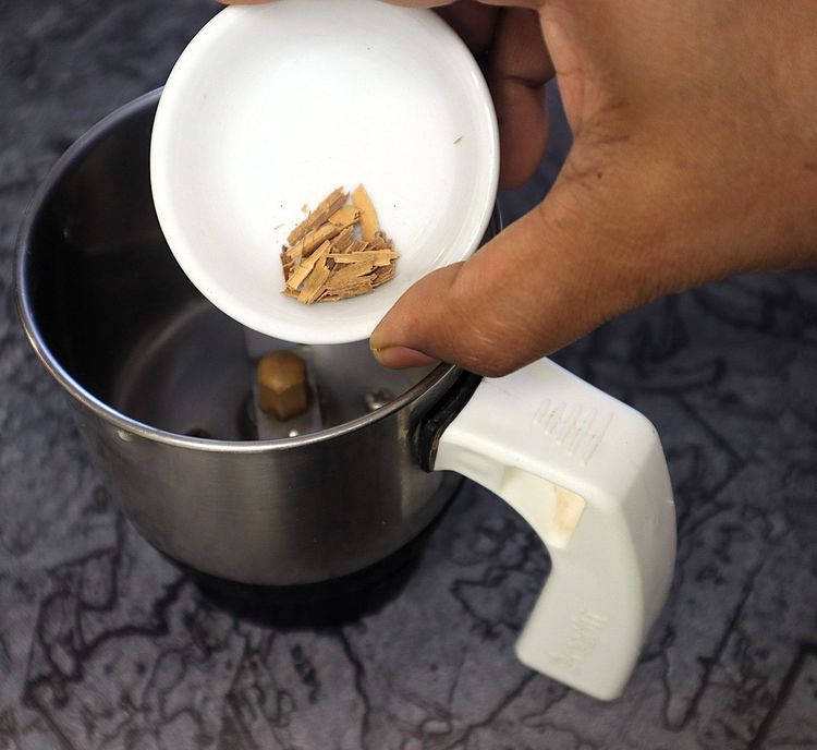 Step 2.2: In a mixer jar, blend cinnamon stick, cloves, green cardamom, star anise, bay leaf, cumin seeds, coriander seeds, black pepper, whole cashews, and poppy seeds into a fine powder