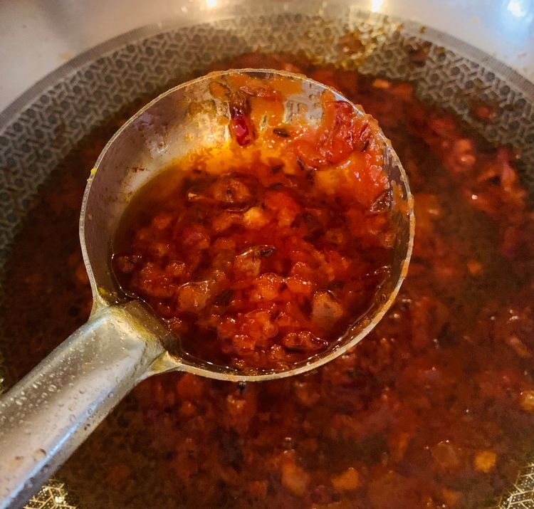 Step 2.1: Add the ground or chopped tomatoes and cook until the tomatoes are soft and the oil starts to separate from the mixture