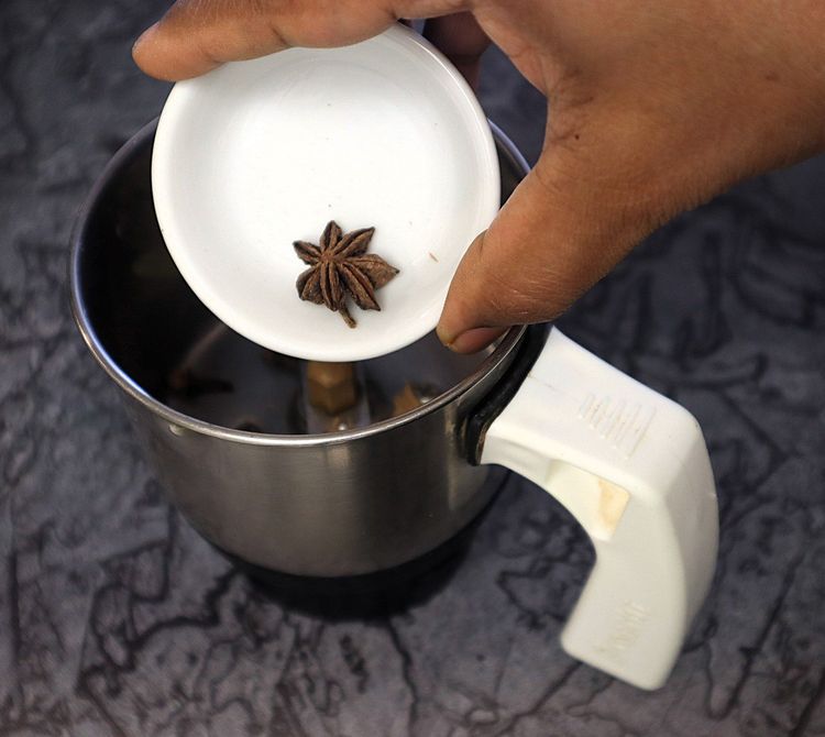 Step 2.5: In a mixer jar, blend cinnamon stick, cloves, green cardamom, star anise, bay leaf, cumin seeds, coriander seeds, black pepper, whole cashews, and poppy seeds into a fine powder