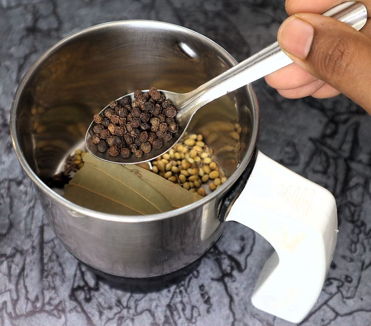 Step 2.9: In a mixer jar, blend cinnamon stick, cloves, green cardamom, star anise, bay leaf, cumin seeds, coriander seeds, black pepper, whole cashews, and poppy seeds into a fine powder