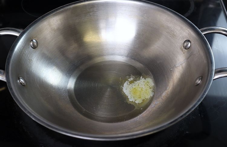 Step 3.4: Place a kadai over medium flame and add oil and butter