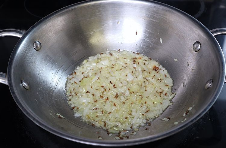 Step 3.3: Add finely chopped onions and roast until they turn light golden in color