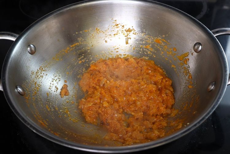 Step 3.4: Add tomato puree and cook until oil releases from the curry