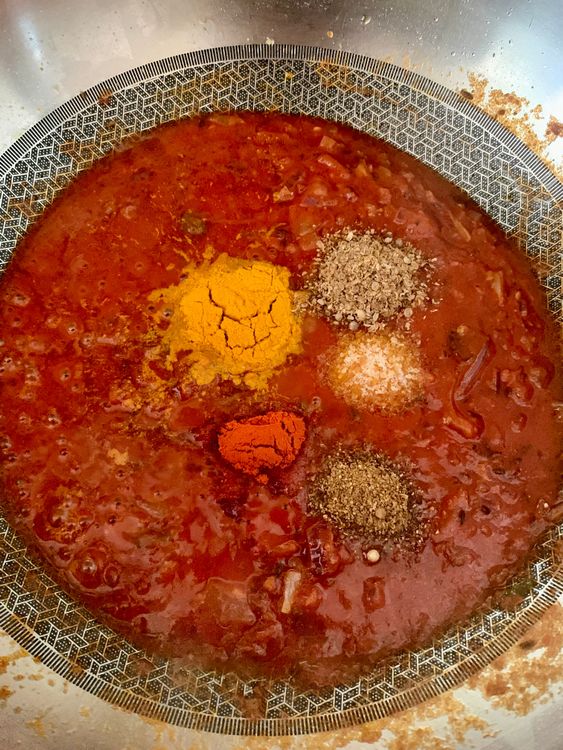 Step 1.1: Add the ground tomatoes, red chilli powder, turmeric powder, coriander powder, garam masala powder, salt, and [Chinese 5-spice powder](https://www