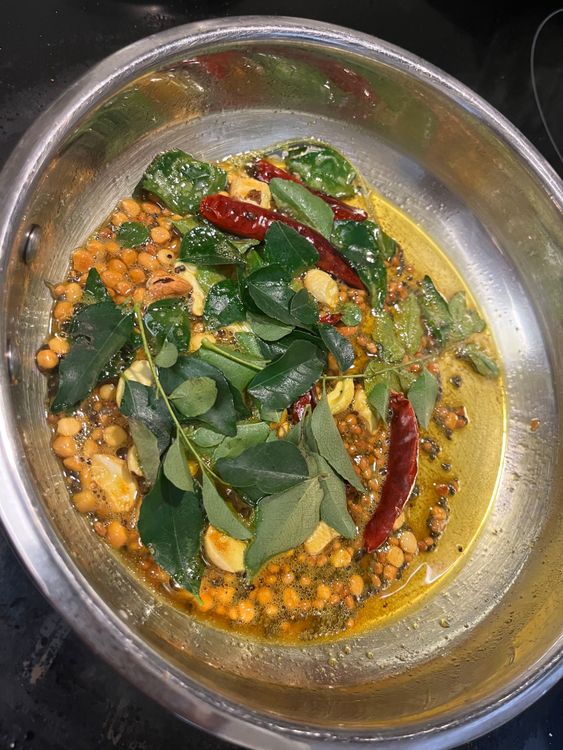 Step 4.1: When golden, add dried red chillies and curry leaves