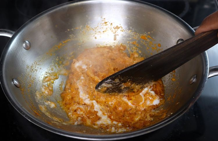 Step 3.2: Add curd and fry on low flame until it incorporates into the oil