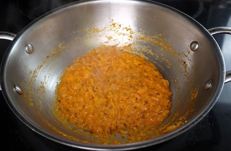 Step 3.3: Add curd and fry on low flame until it incorporates into the oil