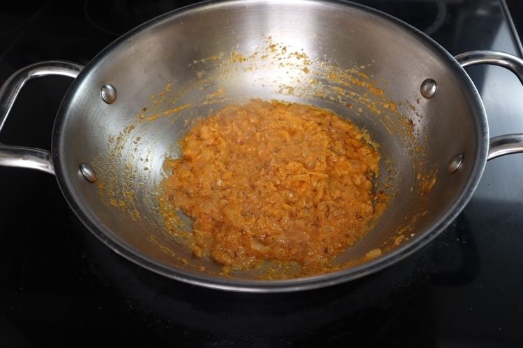 Step 3.4: Add curd and fry on low flame until it incorporates into the oil